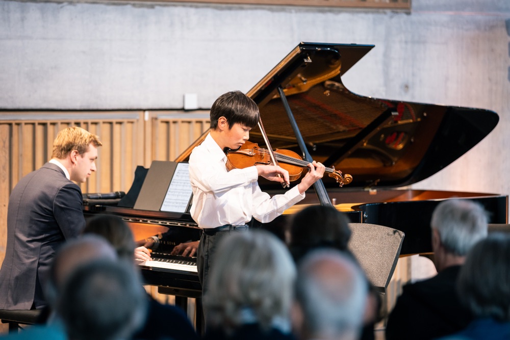 Student performing violin with piano accompaniment
