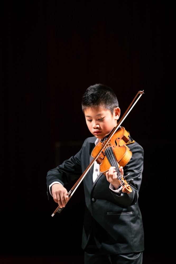 Student performing a solo violin recital